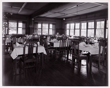 A black and white photograph taken at Mary Lodge Guest House in Marysville. The photograph is of the indoor dining area in the guest house.