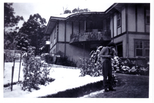 A black and white photograph taken at Mary Lodge Guest House in Marysville. The photograph was taken of an unknown lady standing out the front of Mary Lodge in April 1944.