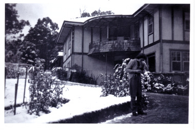A black and white photograph taken at Mary Lodge Guest House in Marysville. The photograph was taken of an unknown lady standing out the front of Mary Lodge in April 1944.