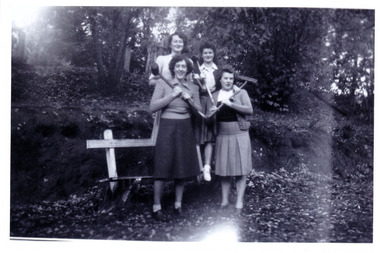A black and white photograph taken at Mary Lodge Guest House in Marysville. The photograph was taken of an unknown group of people during a croquet game at Mary Lodge in April 1944.wfall in April 1944.