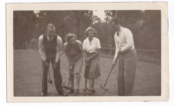 A black and white photograph taken at Mary Lodge Guest House in Marysville. The photograph is of a group of four unknown people playing croquet. The photograph was taken in 1941.