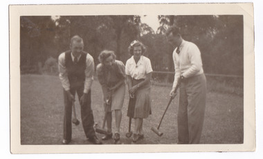 A black and white photograph taken at Mary Lodge Guest House in Marysville. The photograph is of a group of four unknown people playing croquet. The photograph was taken in 1941.