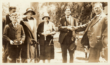 A digital copy of a black and white photograph of William Chester shaking hands with an unknown VIP.