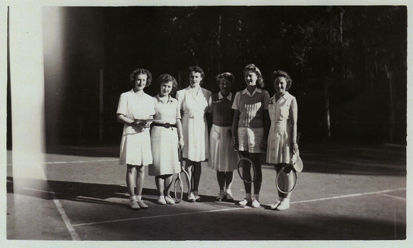 A copy of a black and white photograph of an unknown group of ladies standing on the tennis court at Kooringa Guest House in Marysville. The original photograph was taken in 1947.