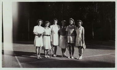 A copy of a black and white photograph of an unknown group of ladies standing on the tennis court at Kooringa Guest House in Marysville. The original photograph was taken in 1947.