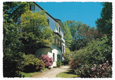 A colour postcard from Kooringa Guest House in Marysville. The postcard was produced by Murray Views as a souvenir of Marysville. On the reverse of the postcard is a space to write a message and an address and to place a postage stamp. The postcard is unused.