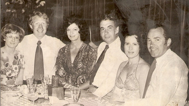 A copy of a black and white photograph of Barry and Kathy Brenton, the owners of Kooringa Guest House, with two couples sitting at a dinner table. The two couples are unknown.