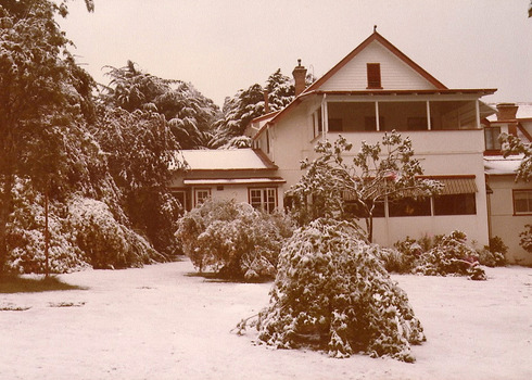 A copy of a sepia photograph taken at Kooringa Tourist House in Marysville. The photograph is of the main building after a snowfall.
