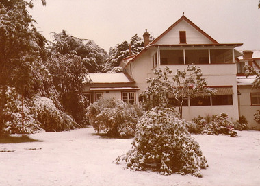A copy of a sepia photograph taken at Kooringa Tourist House in Marysville. The photograph is of the main building after a snowfall.