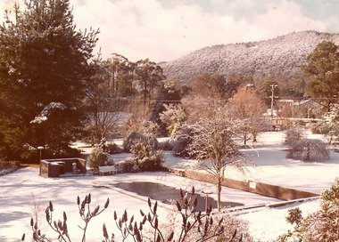 A copy of a sepia photograph taken at Kooringa Tourist House in Marysville. The photograph is of the swimming pool at Kooringa after a snowfall.
