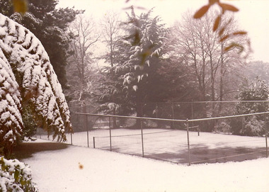 A copy of a sepia photograph taken at Kooringa Tourist House in Marysville. The photograph is of the tennis court at Kooringa after a snowfall.