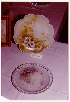 A group of four colour photographs taken at Mary-Lyn Guest House in Marysville. Mary-Lyn was a part of the Mary Chain of guest houses built by Eric Dowdle during the Depression years. The photographs are of pieces of china painting that were produced as the result of a class held at Mary-Lyn.
