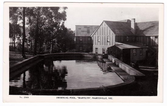 A black and white postcard from Marylyn Guest House in Marysville. Marylyn was a part of the Mary Chain of guest houses built by Eric Dowdle in the Depression years. The postcard was produced by the Rose Stereograph Company as a souvenir of Marysville. On the reverse of the postcard is a space to write a message and an address and to place a postage stamp. The postcard is unused.