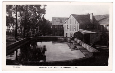 A black and white postcard from Marylyn Guest House in Marysville. Marylyn was a part of the Mary Chain of guest houses built by Eric Dowdle in the Depression years. The postcard was produced by the Rose Stereograph Company as a souvenir of Marysville. On the reverse of the postcard is a space to write a message and an address and to place a postage stamp. The postcard is unused.