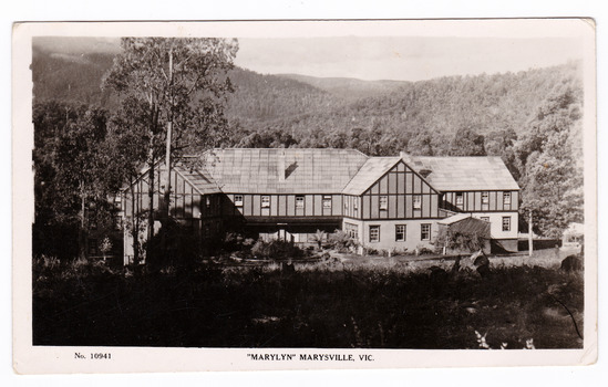 A black and white postcard from Marylyn Guest House in Marysville. Marylyn was a part of the Mary Chain of guest houses built by Eric Dowdle in the Depression years. The postcard was produced by the Rose Stereograph Company as a souvenir of Marysville. On the reverse is a hand-written note.