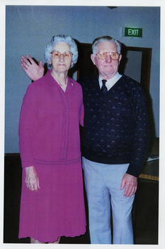 A copy of a colour photograph of Ron and Mavis Jackson who stayed at Mary-Lyn Guest House in Marysville. Mary-Lyn was a part of the Mary Chain of guest houses built by Eric Dowdle in the Depression years. Ron and Mavis stayed at Mary-Lyn for to celebrate their 50th wedding anniversary in 1996.