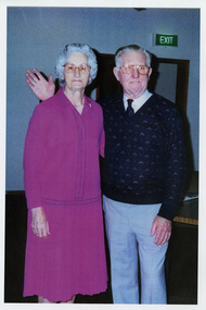 A copy of a colour photograph of Ron and Mavis Jackson who stayed at Mary-Lyn Guest House in Marysville. Mary-Lyn was a part of the Mary Chain of guest houses built by Eric Dowdle in the Depression years. Ron and Mavis stayed at Mary-Lyn for to celebrate their 50th wedding anniversary in 1996.