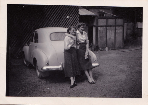 A black and white photograph taken at Mary-Lyn Guest House in Marysville. Mary-Lyn was a part of the Mary Chain of guest houses built by Eric Dowdle in the Depression years. The photograph is of Ailza Rundle and Betty Thomas, both of whom worked at Mary-Lyn from 1954 to 1955.