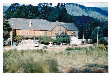 A copy of a colour photograph of Mary-Lyn Guest House in Marysville. Mary-Lyn was a part of the Mary Chain of guest houses built by Eric Dowdle in the Depression years. The photograph was taken in January 1959 and shows a view of the rear of the main building.