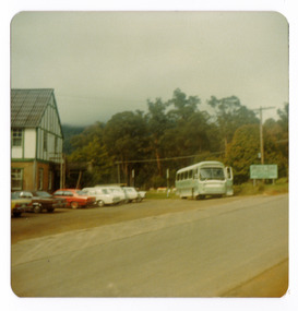 A colour photograph taken at Mary-Lyn Guest House in Marysville. Mary-Lyn was a part of the Mary Chain of guest houses built by Eric Dowdle during the Depression years. The photograph was taken in 1979 and shows a glimpse of the main building with a bus in the foreground. The bus was used to transport children staying at Mary-Lyn for school holidays on various day trips as part of a school holiday program that was run by Mary-Lyn.