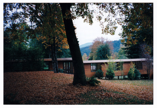 A colour photograph taken at Mary-Lyn Guest House in Marysville. Mary-Lyn was a part of the Mary Chain of guest houses built by Eric Dowdle during the Depression years. The photograph shows a view of the accommodation cabins that were built at Mary-Lyn.