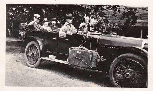 Two black and white photographs of cars travelling along the Black Spur in the 1920s.