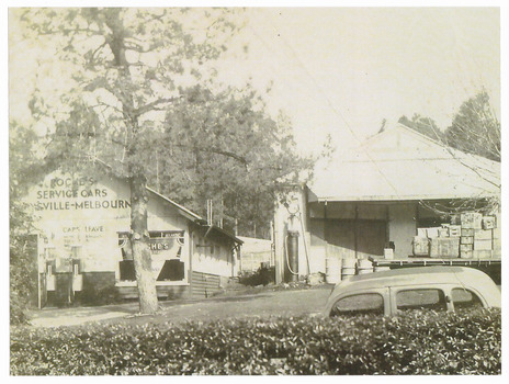 A copy of a black and white photograph of the premises of Roche's Service Cars in Marysville. Roche's provided a tourist car service between Marysville and Melbourne for day trippers.