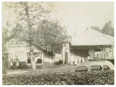 A copy of a black and white photograph of the premises of Roche's Service Cars in Marysville. Roche's provided a tourist car service between Marysville and Melbourne for day trippers.
