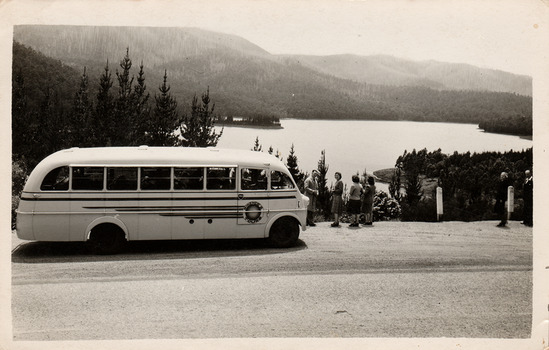 A black and white photograph of a McKenzie's Tourist Services bus at Maroondah Dam. McKenzie's Tourist Services were associated with the growth of Marysville as a tourist destination.