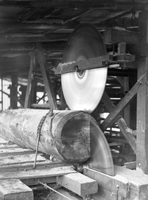 A digital copy of a black and white photograph of a breaking down bench used at the Cambarville timber mill near Marysville. Cambarville was established as a timber mill town in the 1940s. Timber mill owners A. Cameron and F.J. Barton named Cambarville. They established the mill to salvage timber from trees destroyed in the 1939 bushfires. Cambarville was impacted by the 2009 Black Saturday bushfires and any remaining structures were destroyed. The original photograph was taken in November 1945.