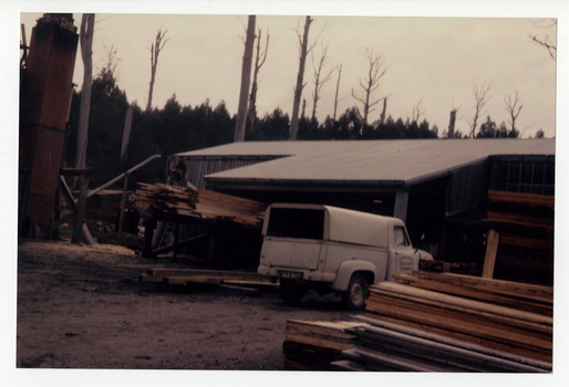 A copy of a colour photograph of the Cambarville timber mill in Victoria. Cambarville was established as a timber mill town in the 1940s. Timber mill owners A. Cameron and F.J. Barton named Cambarville. They established the mill to salvage timber from trees destroyed in the 1939 bushfires. Cambarville was impacted by the 2009 Black Saturday bushfires and any remaining structures were destroyed. The original photograph was taken in 1960.