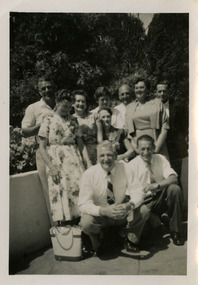 A black and white photograph of a group of men and ladies. Two of the men in the photograph worked at timber mills near Marysville.