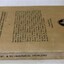 Side view with spine - Tan in colour, fair condition, slightly dog-eared, torn on upper corner, print slightly faded.