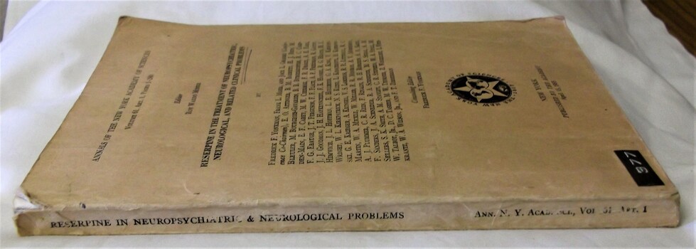 Side view with spine - Tan in colour, fair condition, slightly dog-eared, torn on upper corner, print slightly faded.