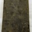 Dark green and brown. Water stains and what appears to be mould growth. Imprinted border around the edges
