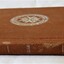 Book spine. Leather bound hardback. Dark tan colour.
