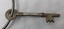 Polished metal key with H A engraved on bow.