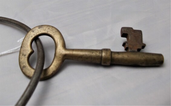 Brass metal key with rust and scratches. 