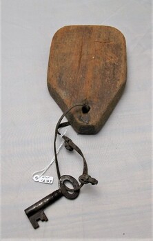 Metal key with wooden tag and leather tie 
