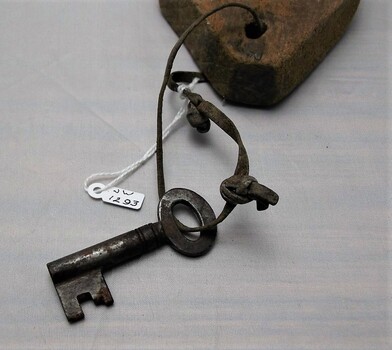 Closer view of key tied to wooden tag