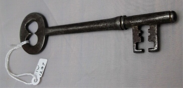An old gaol key with dents and scratches from frequent use 