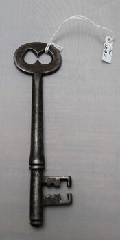 A gaol key with some dents and scratches. Bow and two prong bit.