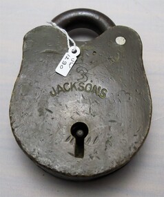 Front view of a padlock with dents and scratches and some engravings.
