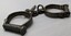 Side view of handcuffs with attached key