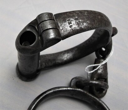 Left handcuff showing engravings  