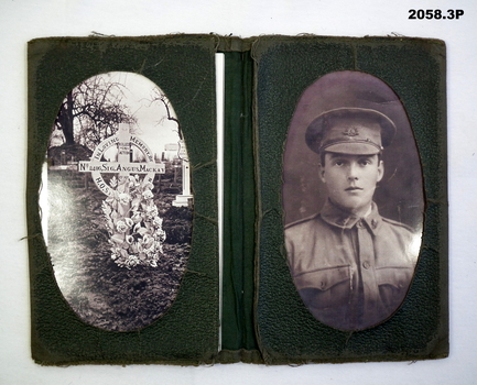 Green wallet & photo of  a grave &soldier.