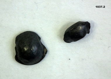 Two small pieces of metal shrapnel