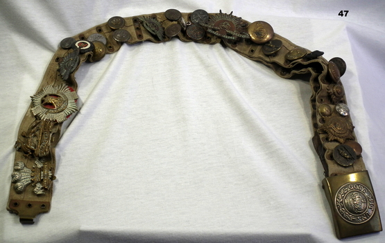 Badges and buttons collected on a belt WW1