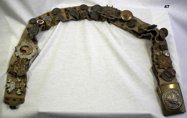 Badges and buttons collected on a belt WW1