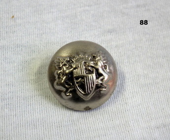Silver uniform button with a coat of arms